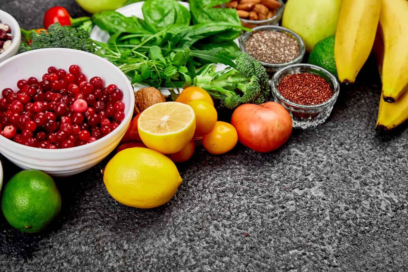 Colorful whole fruits, greens, and seeds shown as vibrant plant-based nutrient sources used by NutriFusion.