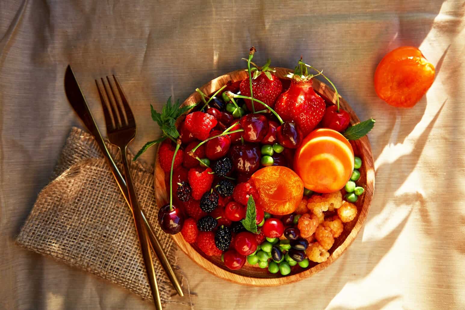 NutriFusion whole-food nutrition is showcased in a vibrant bowl of fresh berries and citrus fruits.