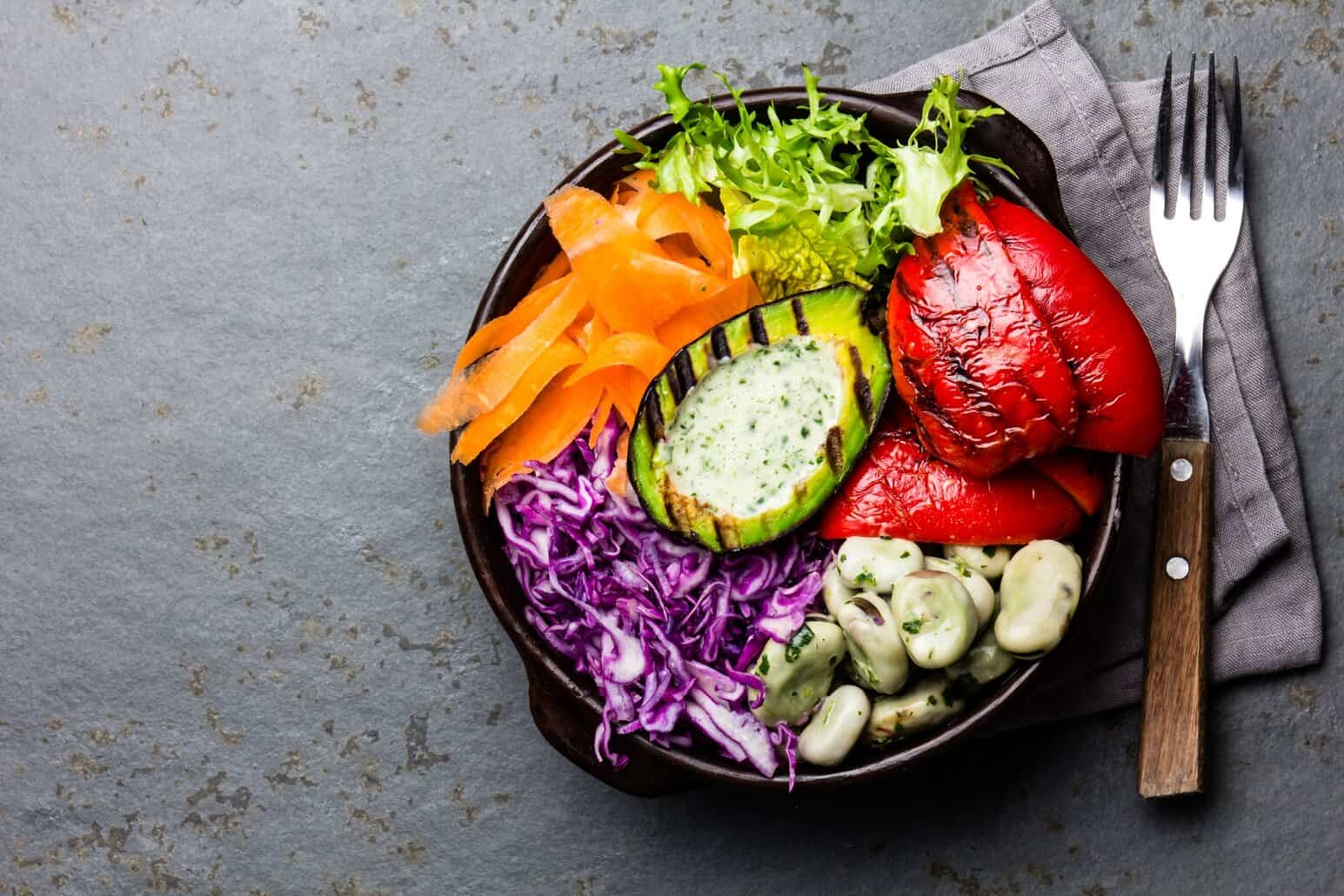 A vibrant bowl of beans, avocado, and fresh vegetables that shows NutriFusion's whole-food nutrition.