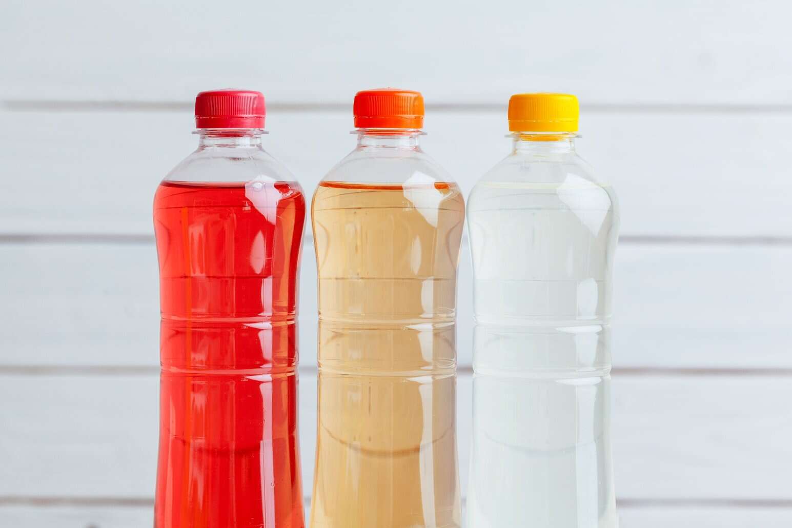 Three bottles of colored electrolyte drinks infused with NutriFusion GrandFusion’s custom blend.