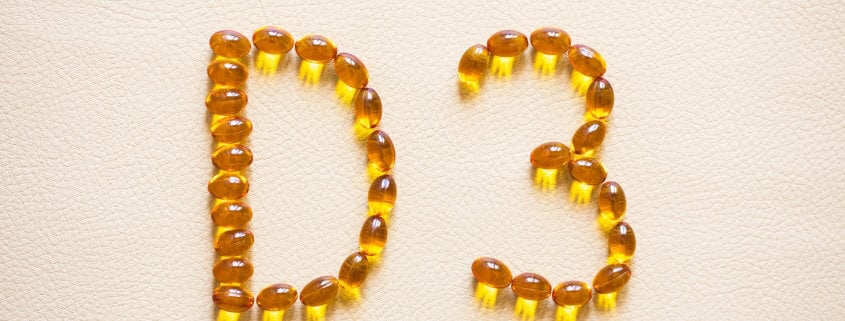 vitamin D3 designed with golden supplement capsules arranged to form the letters “D3”.