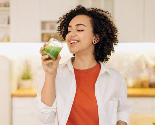 This photo shows a person drinking a plant-based drink for gut health